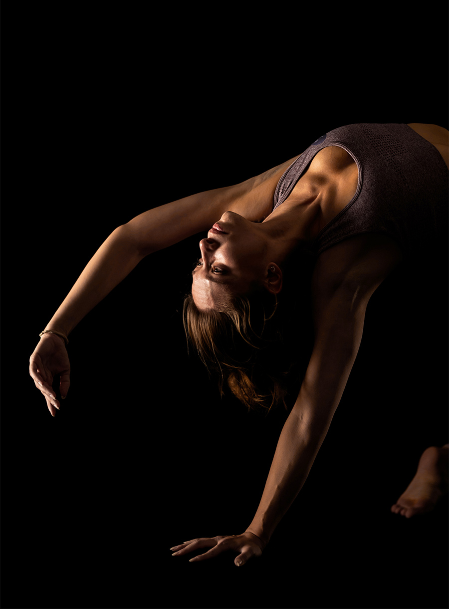 Closeup of woman doing single arm stretch by reaching behind shoulder upside down