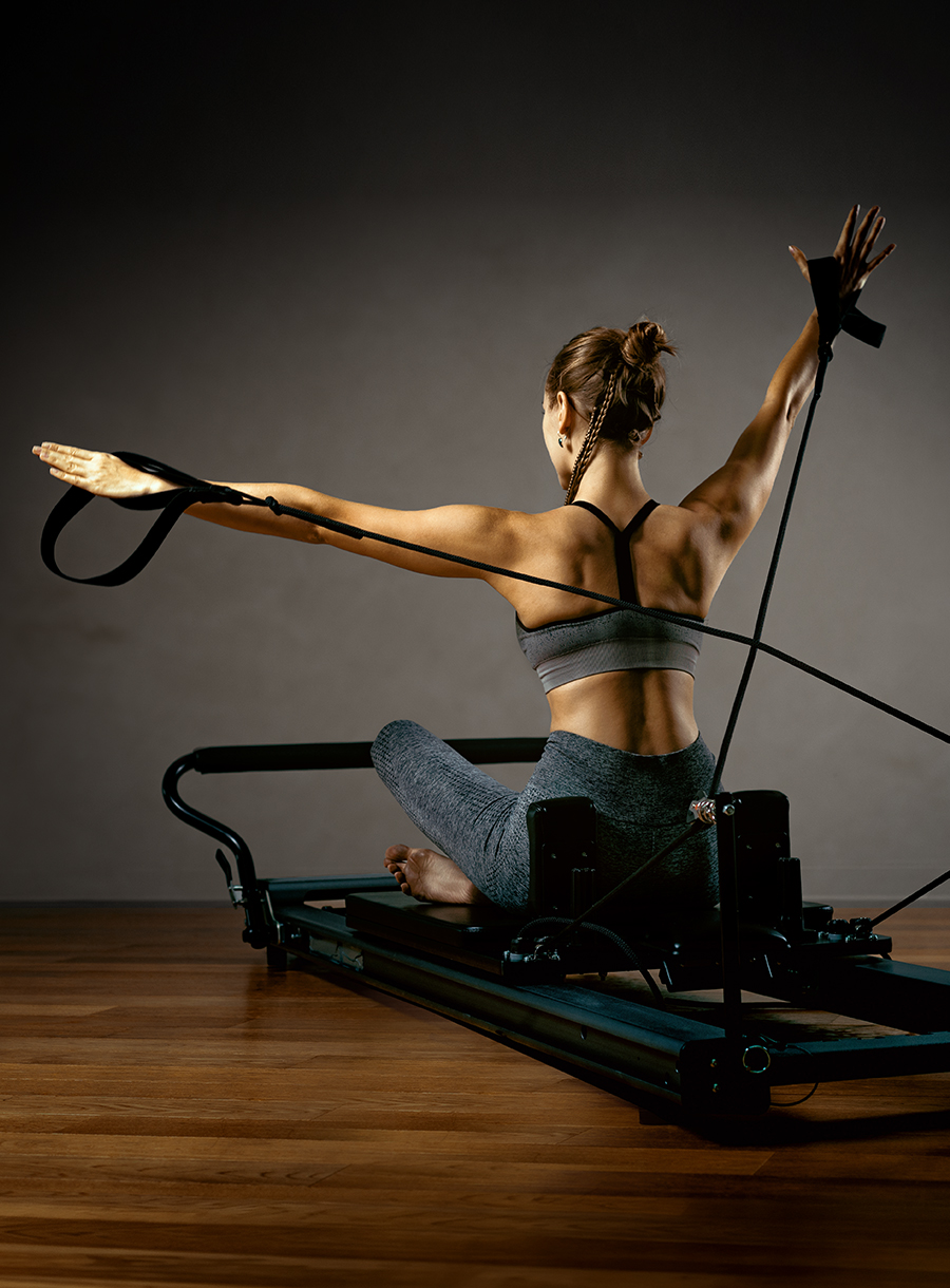 Woman Reformer Arms Wide